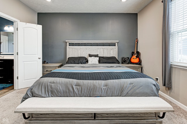 bedroom with carpet and a textured ceiling