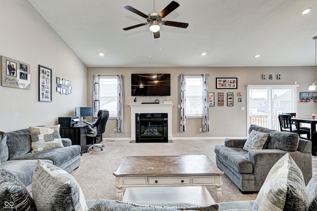 carpeted living room with ceiling fan, a healthy amount of sunlight, and lofted ceiling