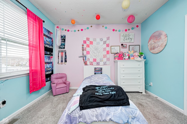 bedroom with carpet and a textured ceiling