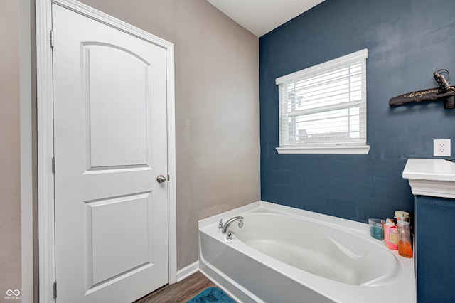 bathroom with hardwood / wood-style floors and a washtub