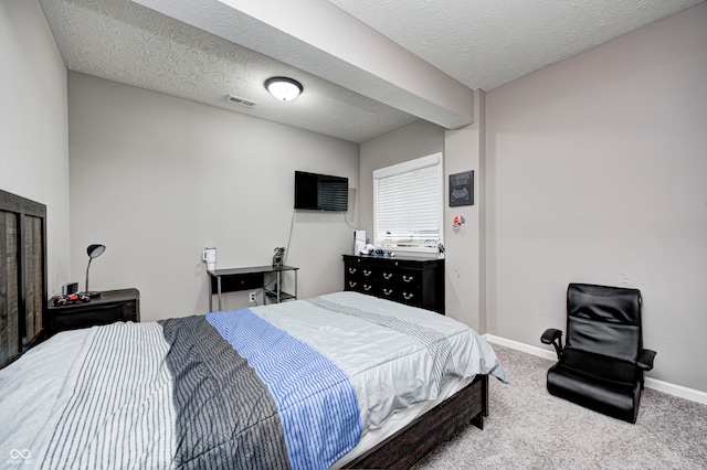 carpeted bedroom featuring a textured ceiling