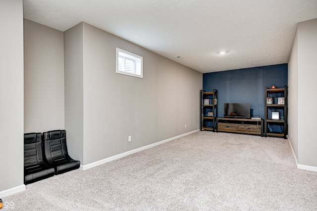 interior space featuring carpet floors and a textured ceiling