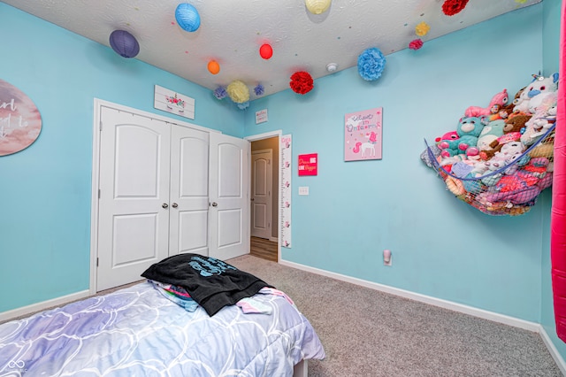 bedroom featuring a textured ceiling and carpet floors