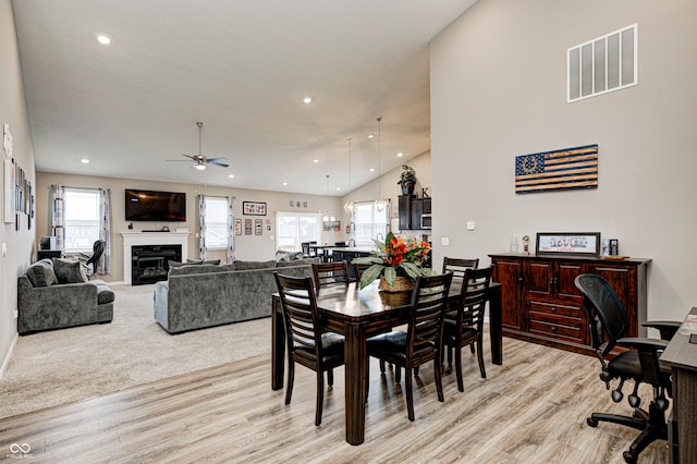 dining space featuring light hardwood / wood-style floors, ceiling fan, and a healthy amount of sunlight