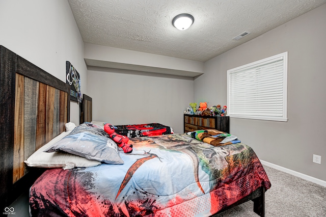 carpeted bedroom with a textured ceiling