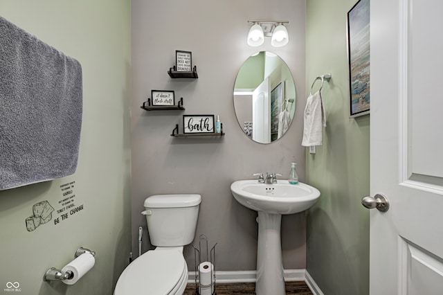 bathroom with sink, wood-type flooring, and toilet