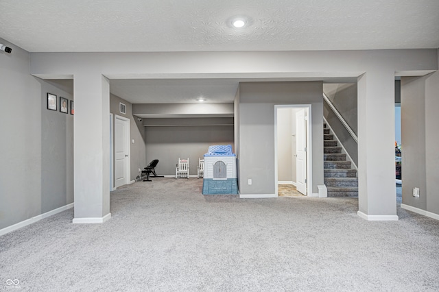 basement with carpet floors and a textured ceiling