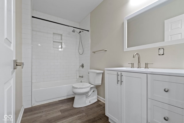 full bathroom featuring vanity, toilet, wood-type flooring, and tiled shower / bath combo