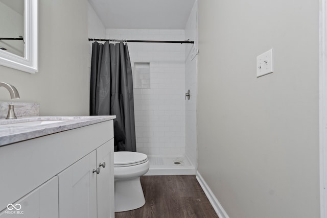 bathroom with hardwood / wood-style flooring, vanity, toilet, and a shower with shower curtain