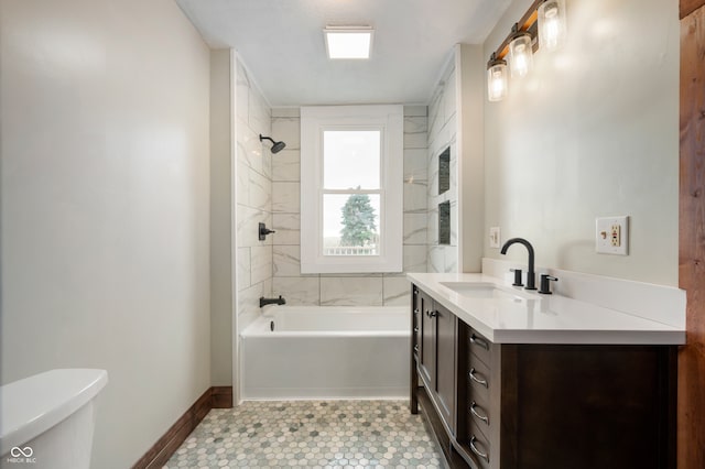 full bathroom with toilet, tiled shower / bath combo, vanity, and tile patterned flooring