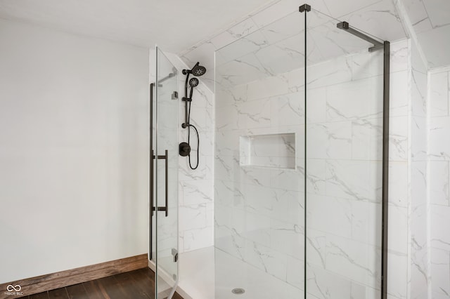 bathroom featuring walk in shower and hardwood / wood-style floors
