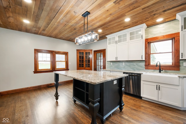 kitchen with stainless steel dishwasher, hanging light fixtures, white cabinets, and a center island