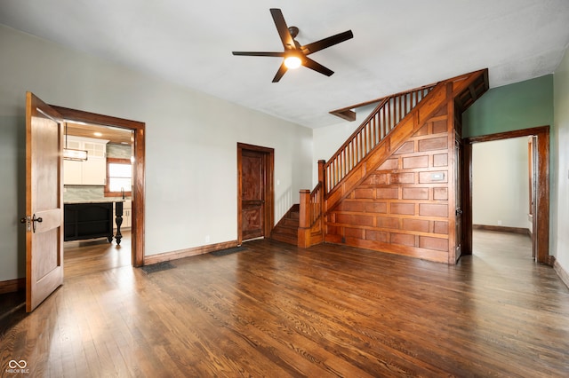 unfurnished living room with dark hardwood / wood-style flooring and ceiling fan
