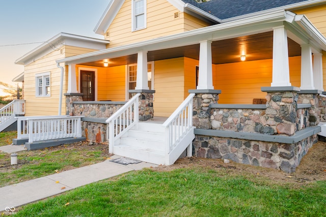 view of exterior entry featuring covered porch