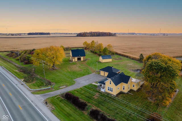 aerial view at dusk featuring a rural view