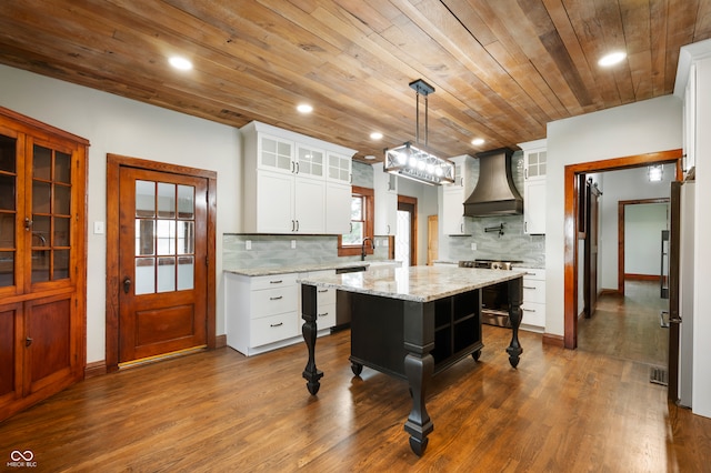 kitchen with stainless steel electric range, white cabinets, custom exhaust hood, wooden ceiling, and a kitchen island