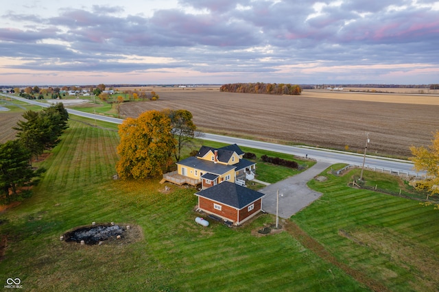 aerial view at dusk featuring a rural view
