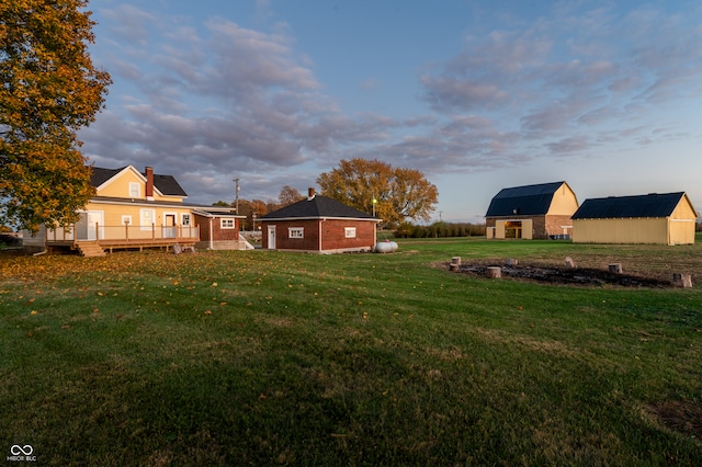 view of yard with an outbuilding and a wooden deck