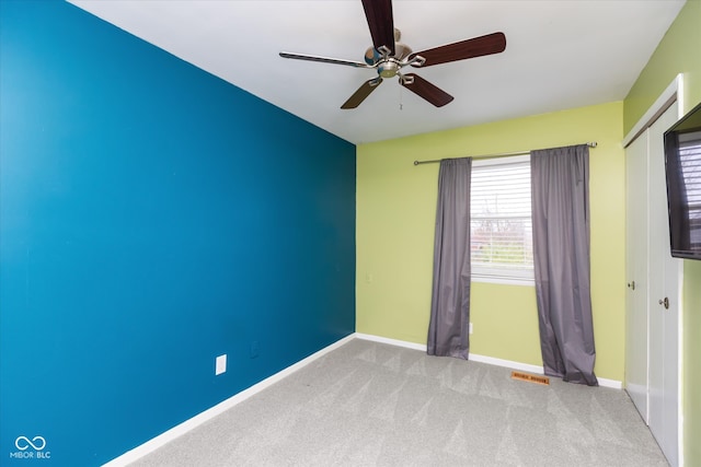 carpeted empty room with ceiling fan