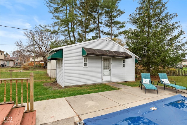 view of outbuilding featuring a lawn