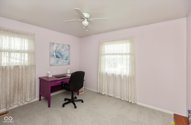 office area featuring light carpet and ceiling fan