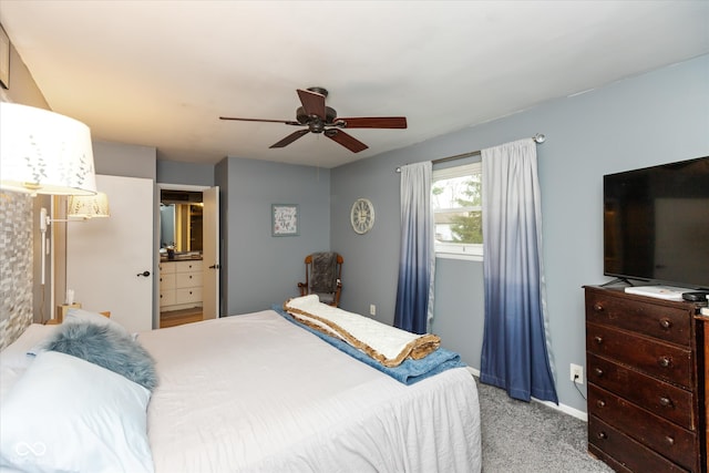 carpeted bedroom with ceiling fan and ensuite bathroom