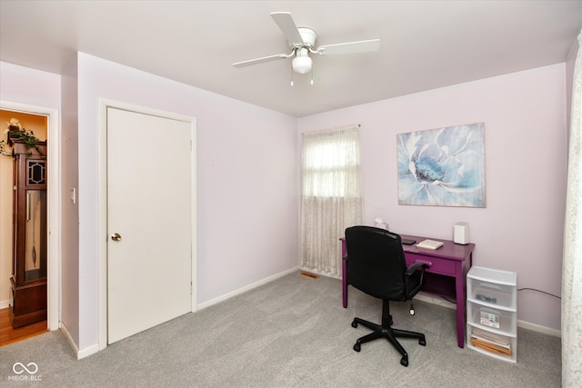 carpeted home office with ceiling fan