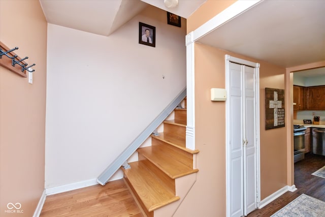 stairs with hardwood / wood-style flooring