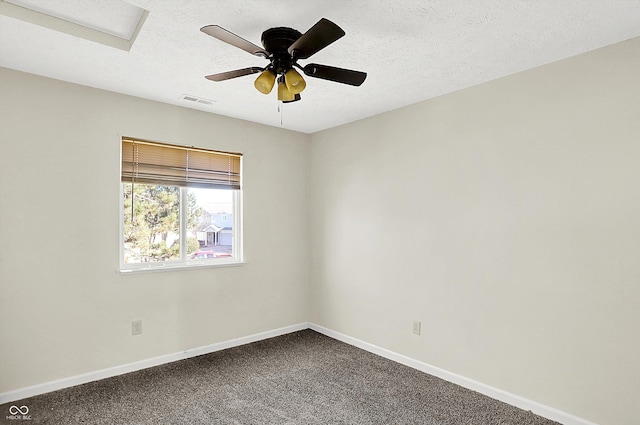 carpeted spare room with a textured ceiling and ceiling fan