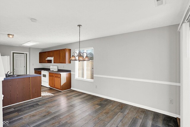 kitchen with pendant lighting, a notable chandelier, dark wood-type flooring, and electric stove