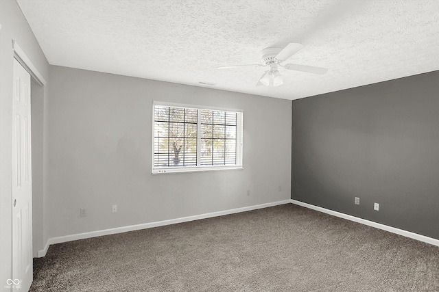 carpeted empty room featuring a textured ceiling and ceiling fan