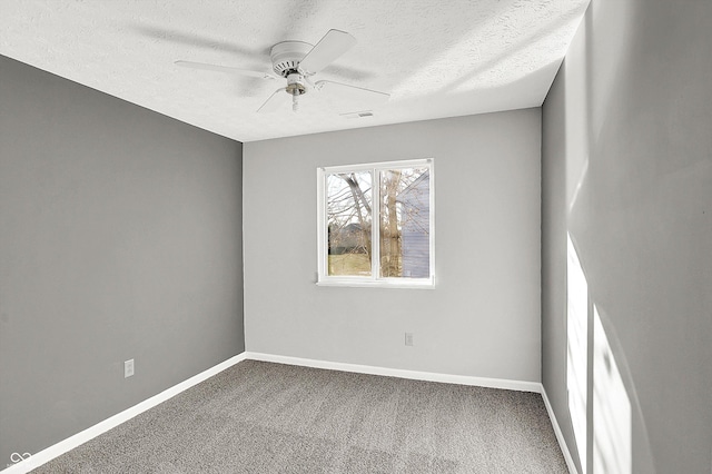 unfurnished room with ceiling fan, carpet floors, and a textured ceiling