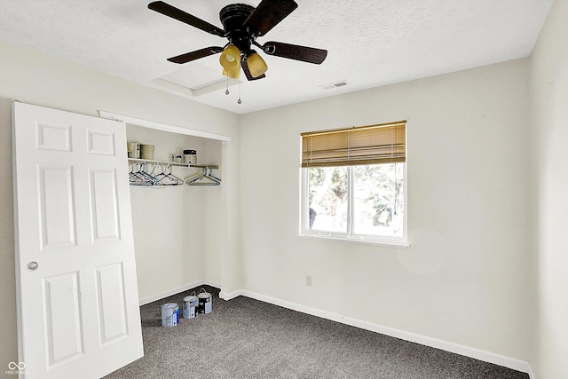 interior space with ceiling fan, carpet floors, and a textured ceiling