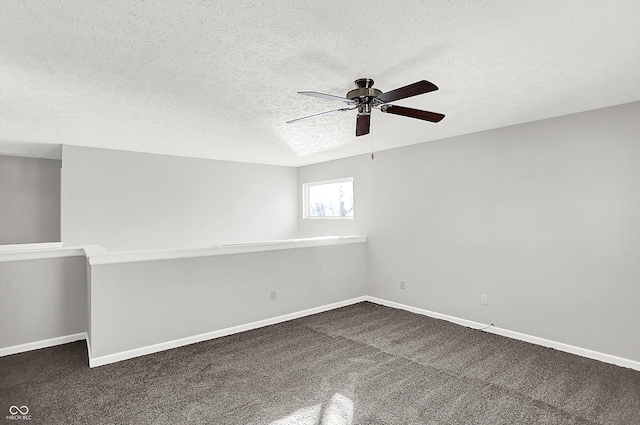 unfurnished room with dark colored carpet, a textured ceiling, and ceiling fan