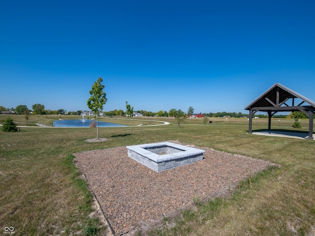 view of storm shelter featuring a water view and a yard