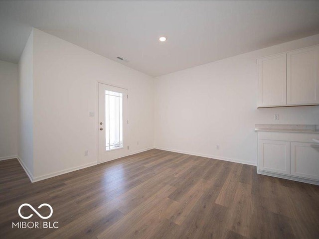 unfurnished living room featuring dark hardwood / wood-style flooring