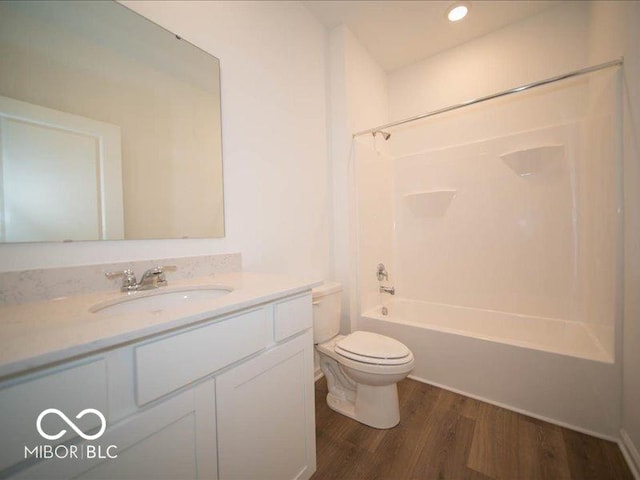 full bathroom featuring vanity, wood-type flooring, bathtub / shower combination, and toilet