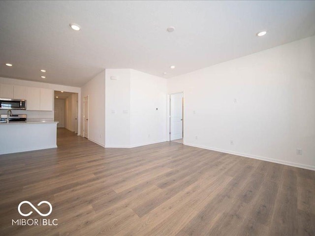 unfurnished living room with hardwood / wood-style flooring