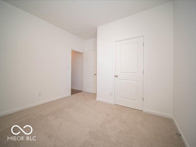 unfurnished bedroom featuring light carpet