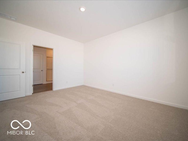 unfurnished room with light colored carpet