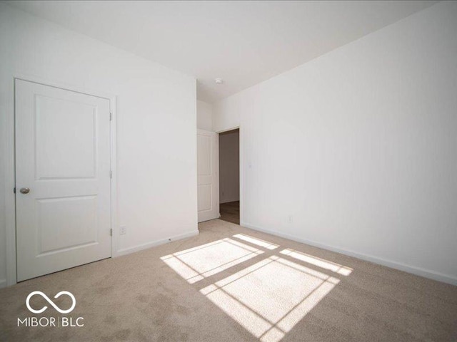 unfurnished bedroom with light colored carpet