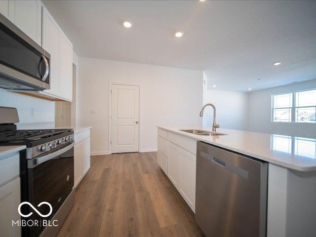 kitchen with white cabinetry, sink, dark hardwood / wood-style flooring, and appliances with stainless steel finishes