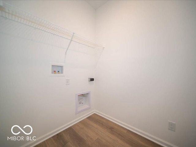 laundry area with hookup for a washing machine, wood-type flooring, and electric dryer hookup