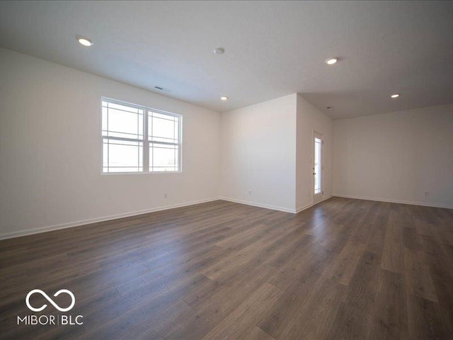 unfurnished room featuring dark hardwood / wood-style flooring