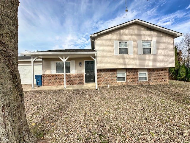 rear view of house with a garage