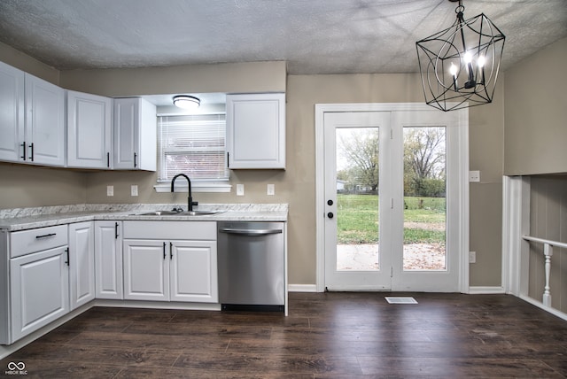 kitchen with dishwasher, pendant lighting, white cabinets, and sink