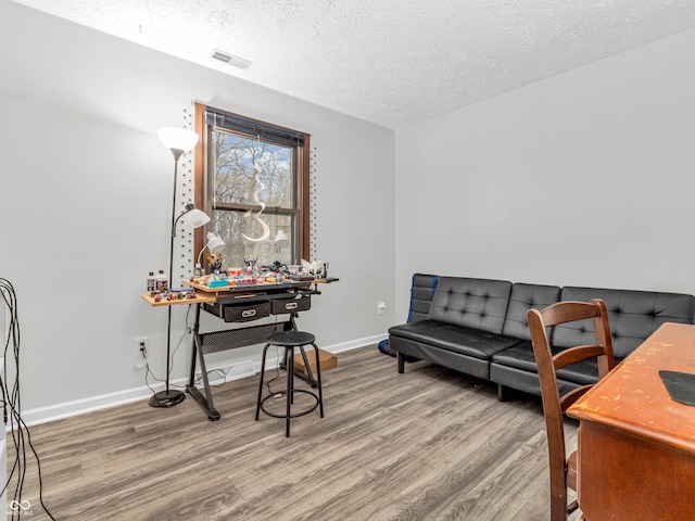 office space with hardwood / wood-style floors and a textured ceiling