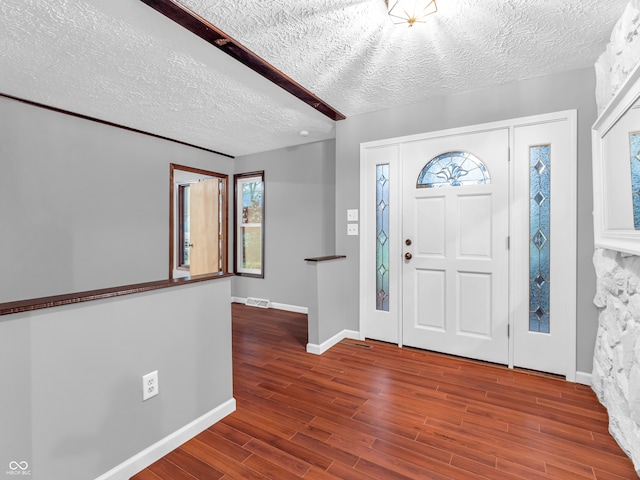 foyer featuring hardwood / wood-style floors and a textured ceiling