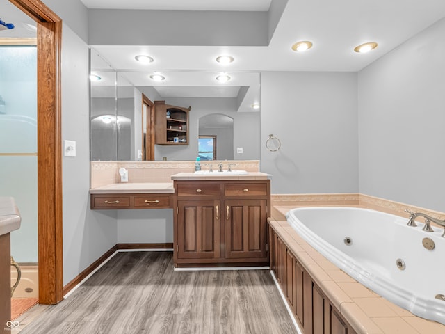 bathroom featuring hardwood / wood-style floors, vanity, and a bathtub