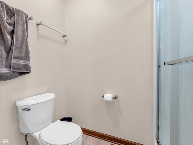 bathroom featuring tile patterned floors and toilet